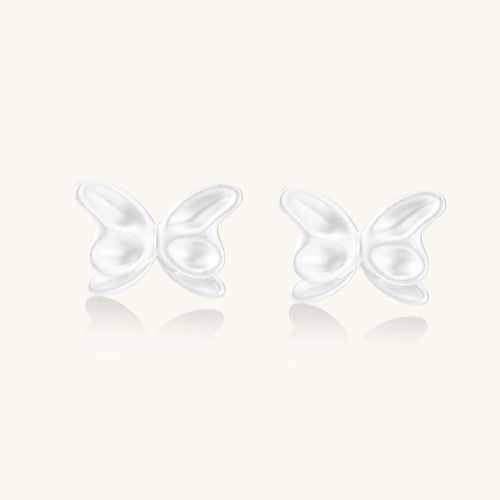 Pair of translucent butterfly-shaped stud earrings with frosted finish and dimensional wing details on white background
